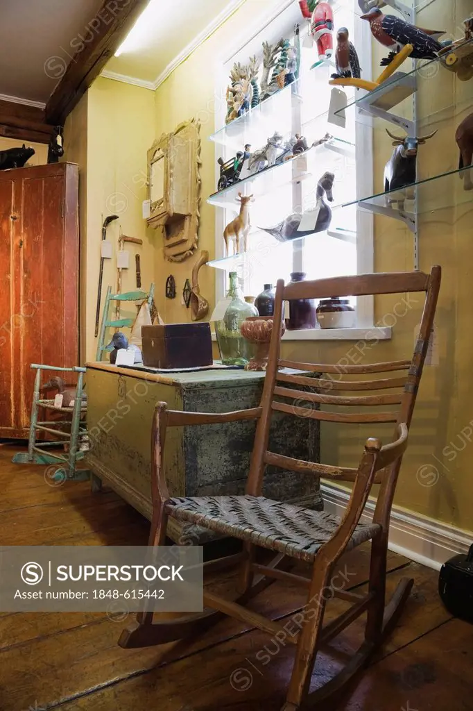 Antique wooden chair, decorative objects and furnishings inside an old residential home and antique store, Lanaudiere, Quebec, Canada. This image is p...