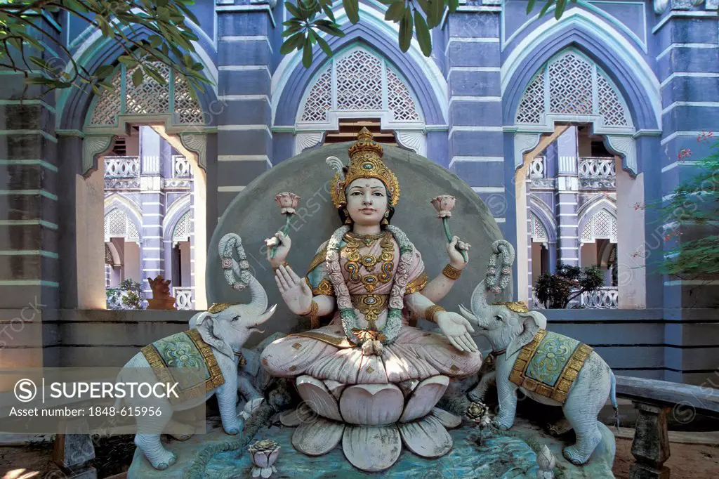 Laxmi or Lakshmi, Hindu goddess standing for happiness, beauty, harmony and prosperity, flanked by two elephants, in front of an old merchant villa, K...