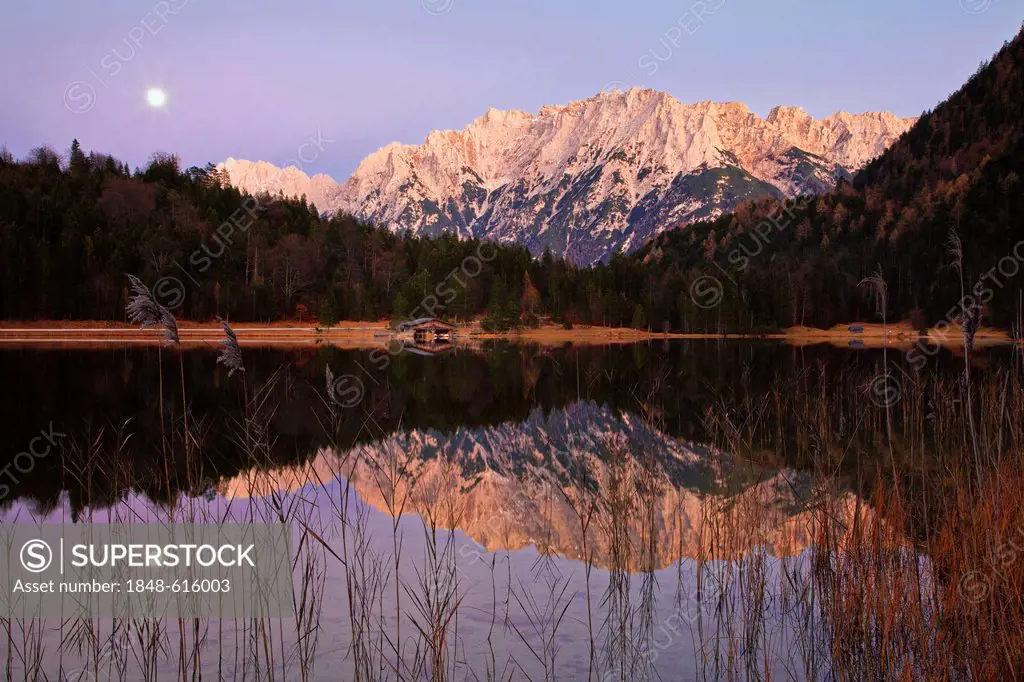 Moon and the Karwendel Mountains reflected in Lake Ferchen, Wetterstein Mountains, Bavaria, Germany, Europe