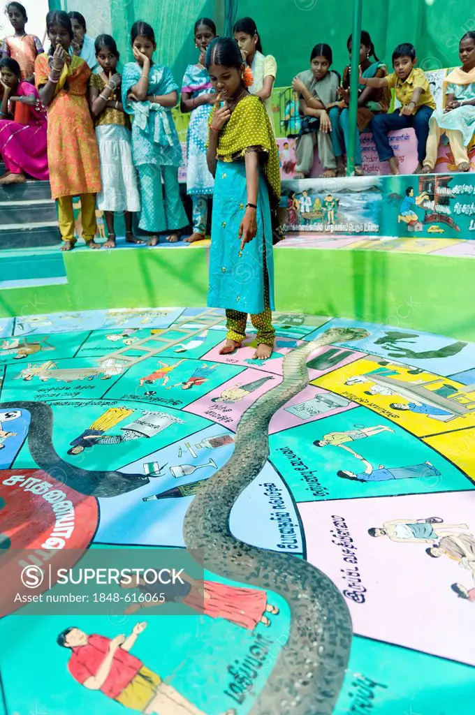 Indian girls playing Snakes and Ladders, Indian Moksha Patamu, an education game against child labour, Kutties Rajiyam, Kids' World, centre for childr...
