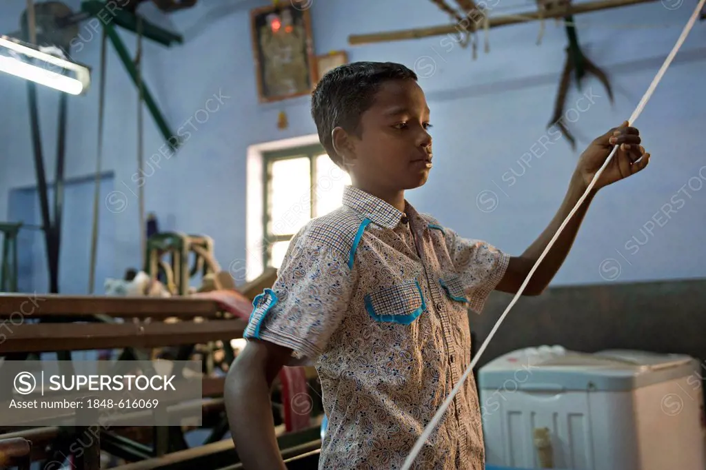 Child labourer working in a mosquito net factory, Karur, Tamil Nadu, South India, India, Asia