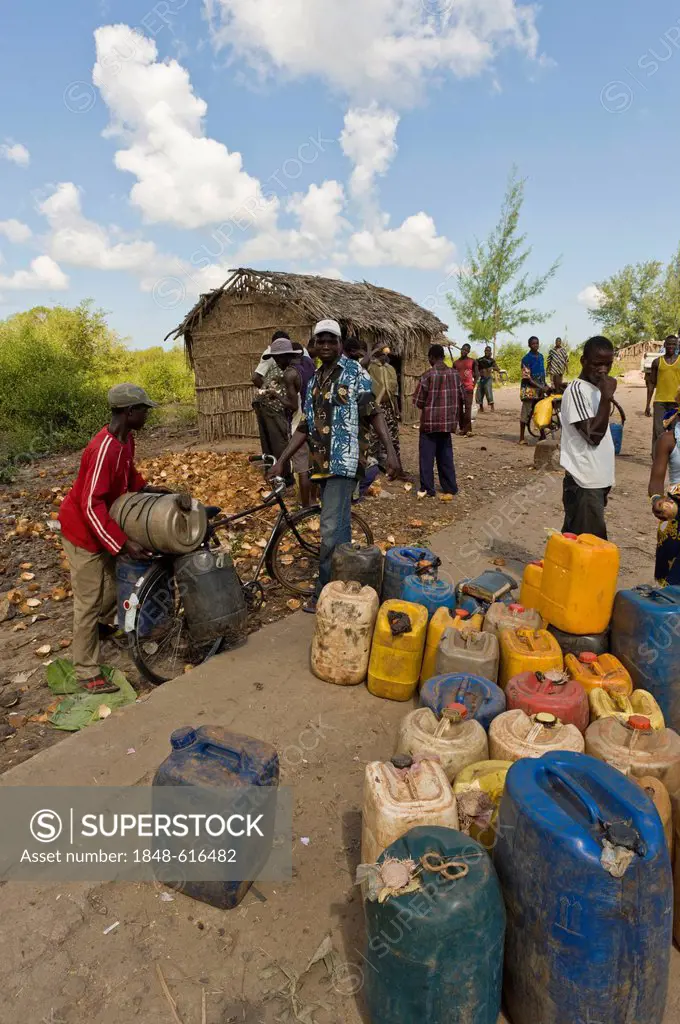 Villagers fetching drinking water in plastic containers from a public tap, Quelimane, Mozambique, Africa