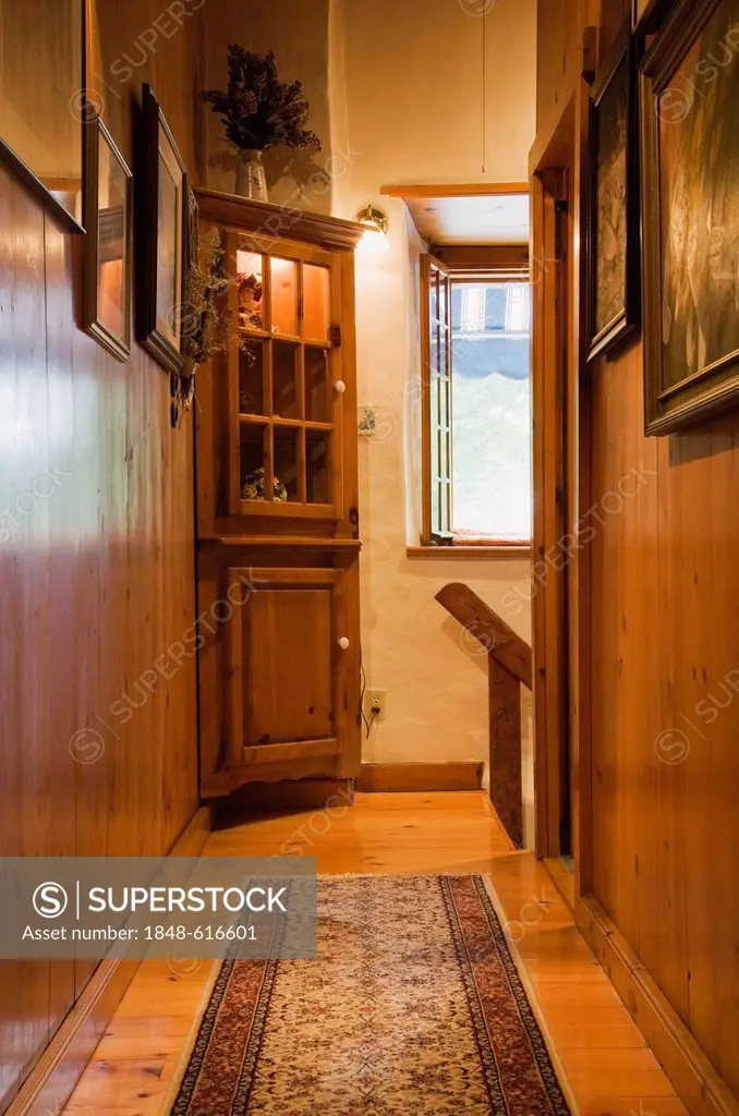 Pinewood hallway on the upstairs floor of an old Canadiana cottage-style residential fieldstone home, circa 1740, Quebec, Canada. This image is proper...