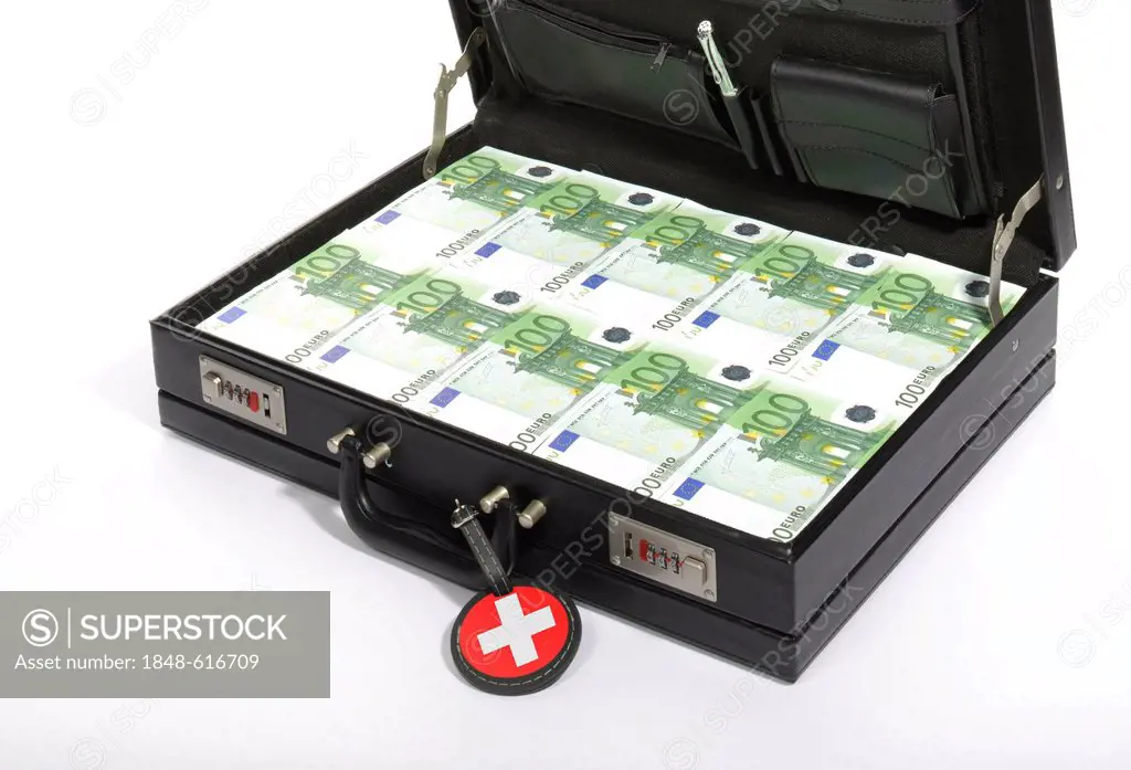 Symbolic image for tax flight to Switzerland, 100-euro banknotes in a briefcase, suitcase of money, luggage tag with a Swiss national flag