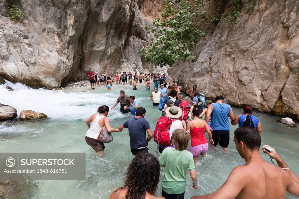 Tourists walking in the water of the gorge, Saklikent Gorge near Tlos and Fethiye, Lycian coast, Lycia, Mediterranean, Turkey, Asia Minor