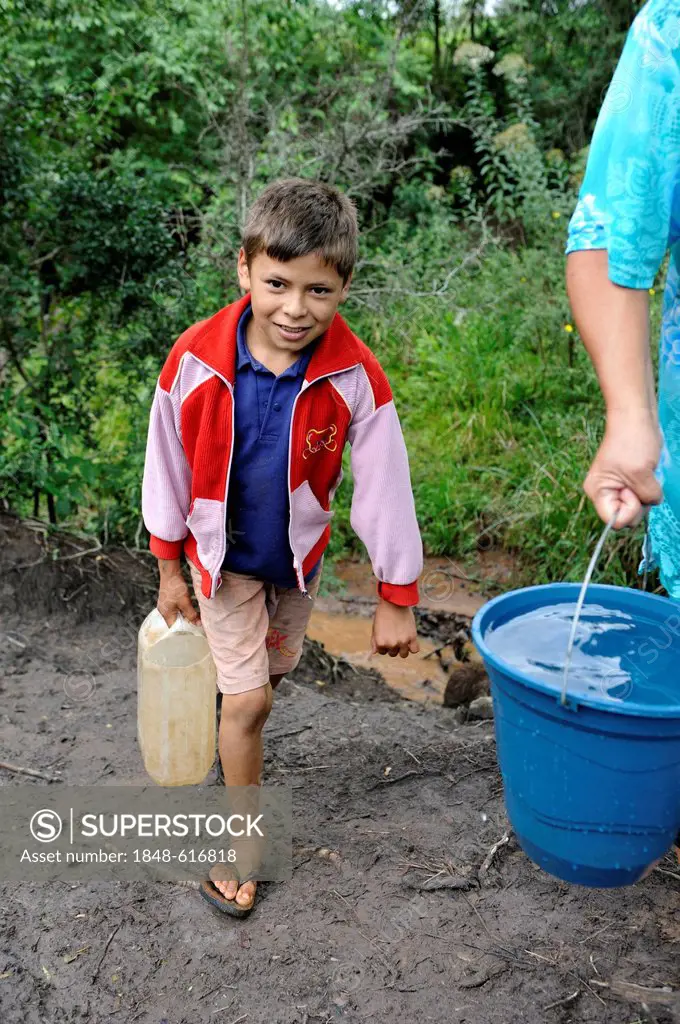 Mother and son fetching water from a stream, Comunidad Martillo, Caaguazu, Paraguay, South America