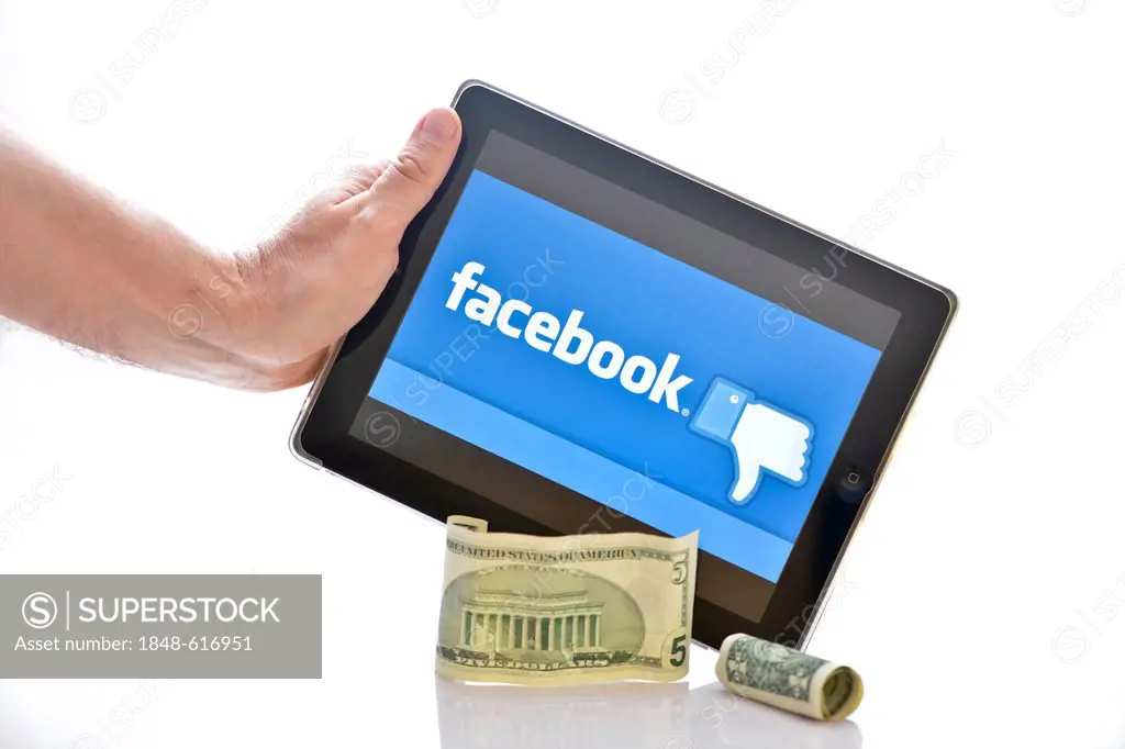 Facebook logo on an iPad, Dollar bills at front, symbolic image for the Facebook IPO