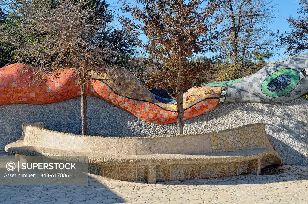 Bench in front of the enclosure wall with a mythological serpent, concrete sculptures covered in mosaics, Queen Califa's Magical Circle, late work of ...