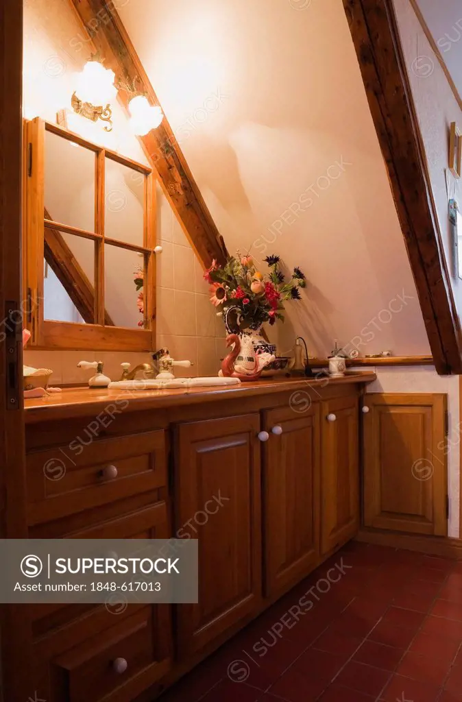 Partial view of the bathroom on the upstairs floor of an old reconstructed Canadiana cottage-style residential log home, 1983, Quebec, Canada. This im...