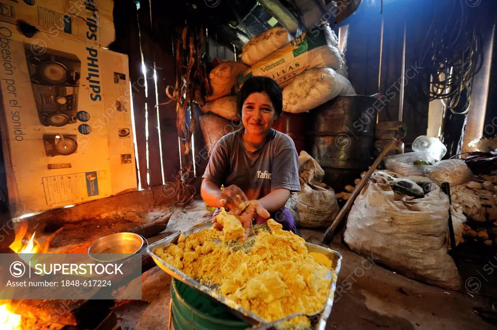 Woman preparing the traditional dish Bory Bory in a simple kitchen on an open fire, soup with corn dumplings, Comunidad Martillo, Caaguazu, Paraguay, ...