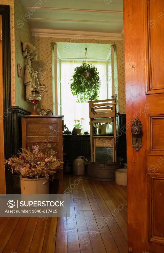 Partial view of a bathroom with antique furnishings in an old Canadiana cottage-style quarry stone residential home, circa 1740, Montreal, Quebec, Can...