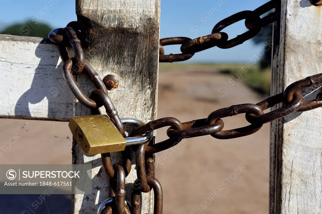 Padlock on a wooden gate of a great land owner, soybean farmers, Gran Chaco, Santiago del Estero province, Argentina, South America