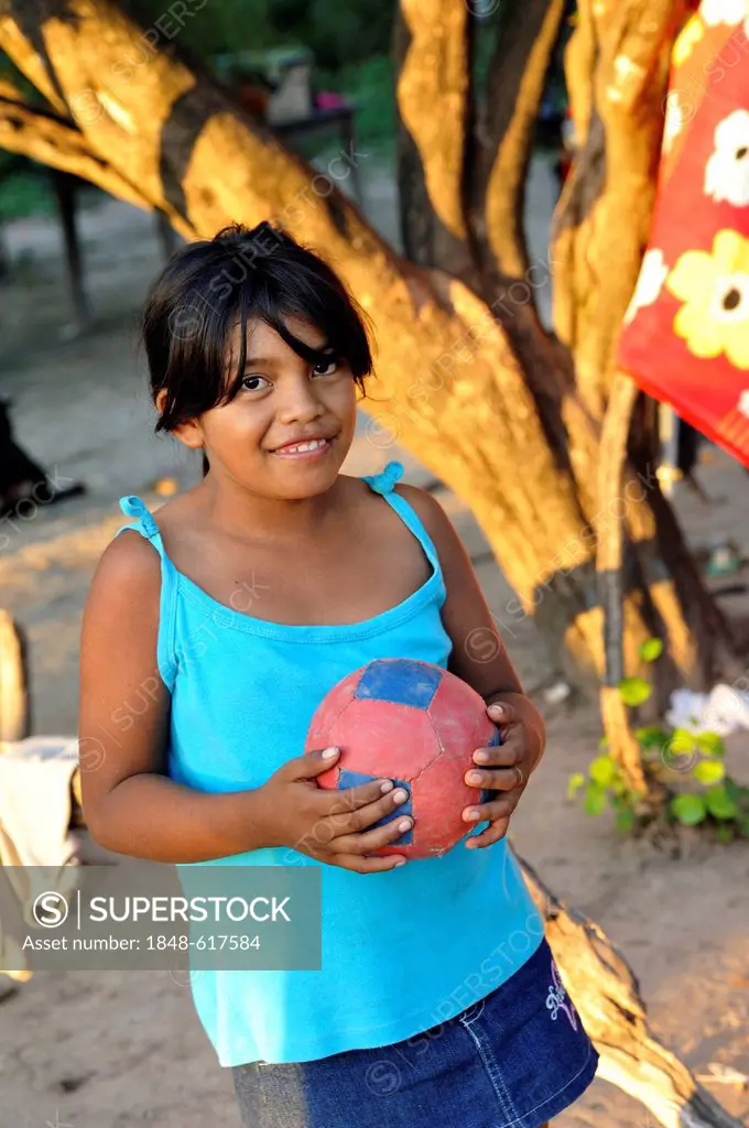 Girl holding a soccer ball, village of Onedi, indigenous Pilaga people, Gran Chaco, Formosa province, Argentina, South America