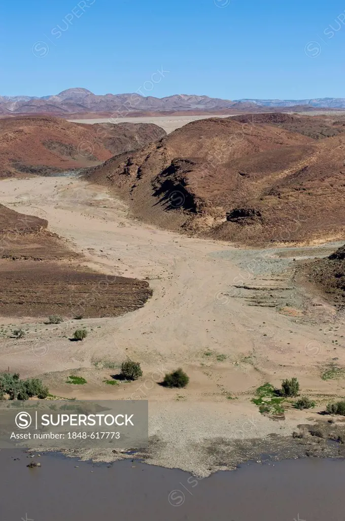 Dry river bed in Richtersveld National Park South Africa, view across the Oranje River from a view point west of Aussenkehr, Namibia, Africa