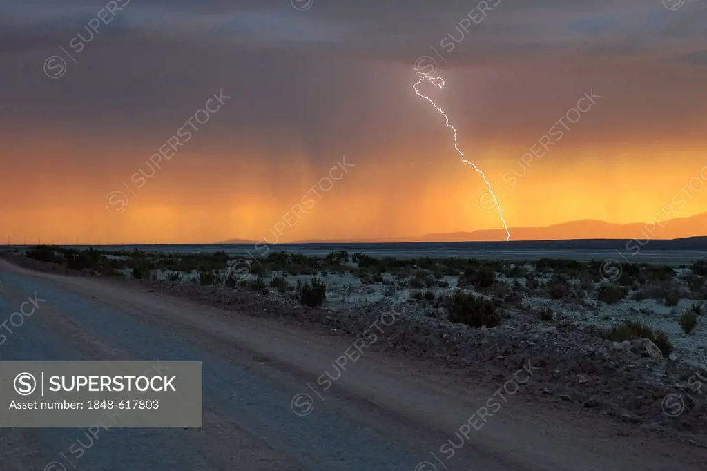 Stormy sky with rain and lightning at sunset, Altiplano, Bolivia, South America
