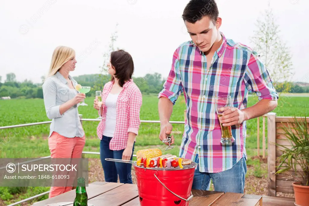 Young people having a barbecue on a terrace