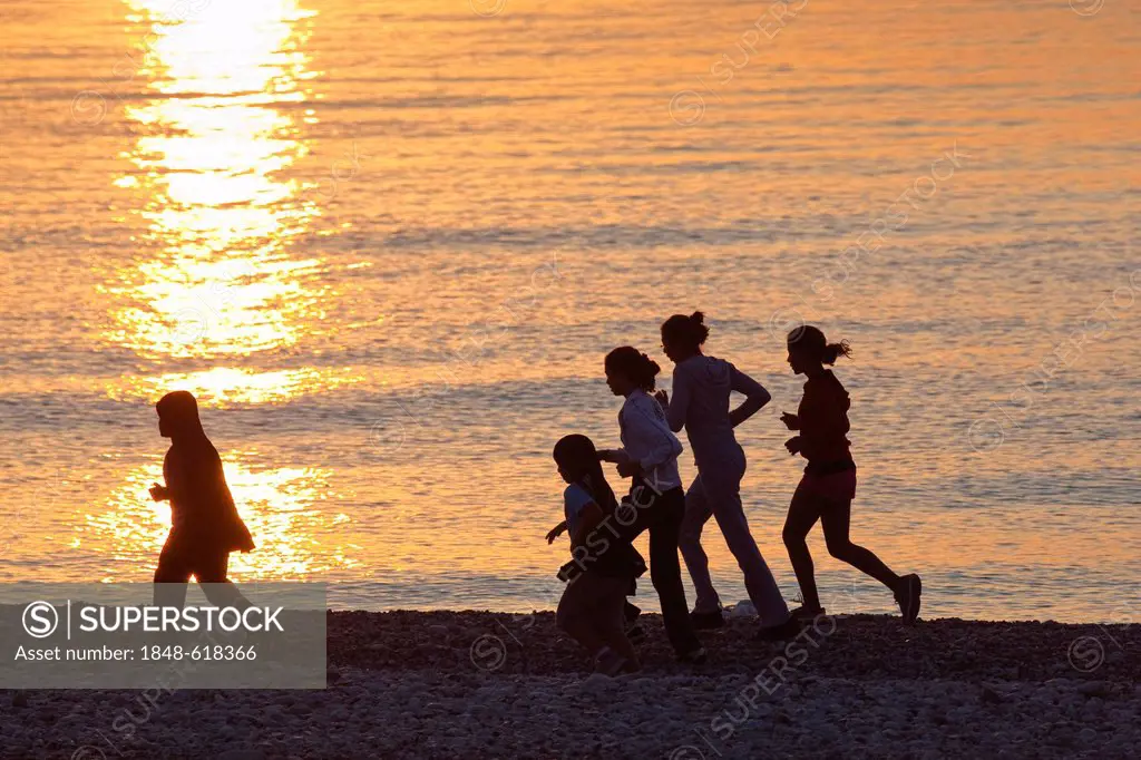 Joggers running on the beach of Cirali, Lycian coast, Lycia, the Aegean, Mediterranean Sea, Turkey, Asia Minor