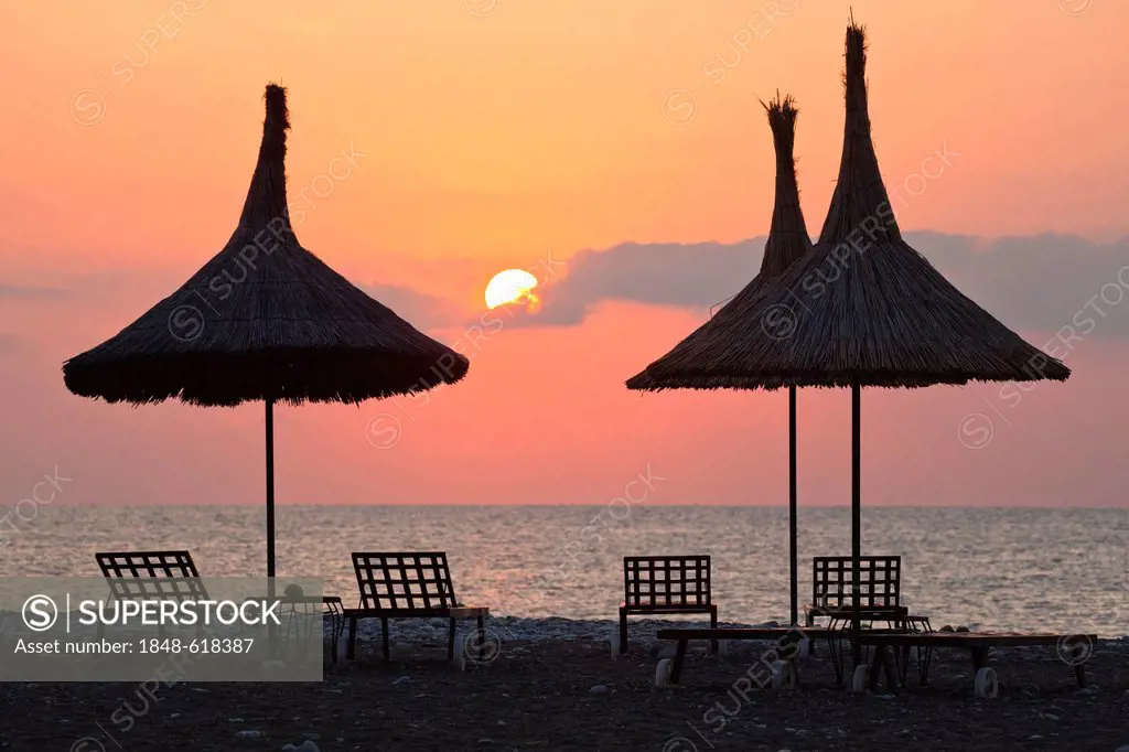 Beach chairs and straw sunshades at sunrise on the beach of Olympos, Lycian coast, Lycia, Aegean, Mediterranean Sea, Turkey, Asia Minor