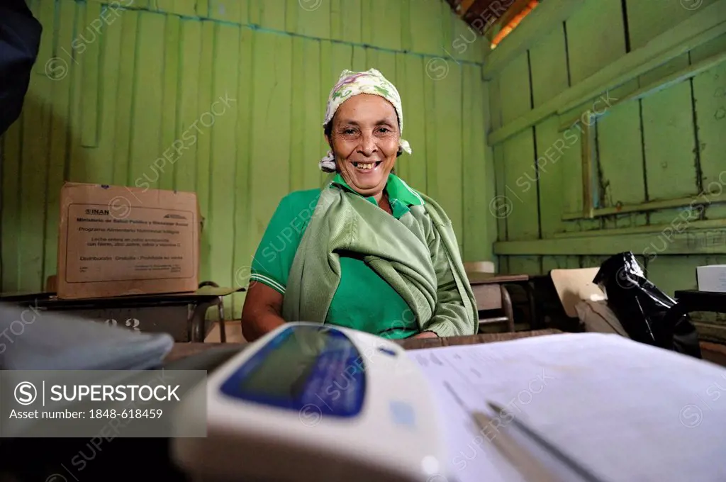 Woman in a makeshift treatment area, the aid organisation provides health services and education for mothers and children in remote rural areas, Comun...