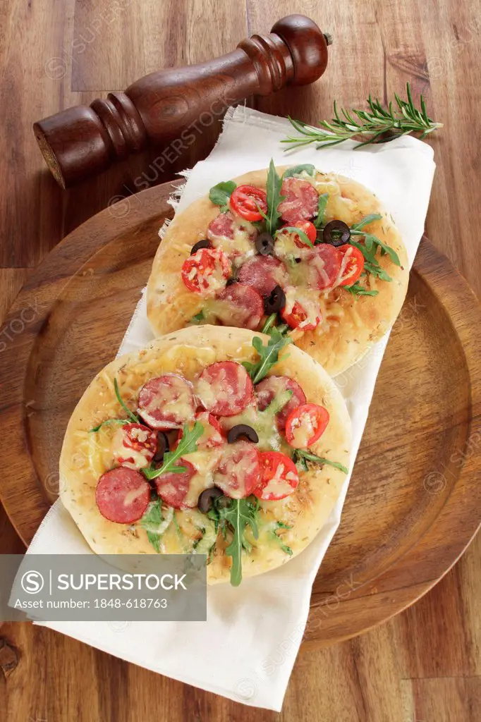 Italian focaccia breads with Cabanossi sausage, rucola, cherry tomatoes, black olives, topped with melted cheese