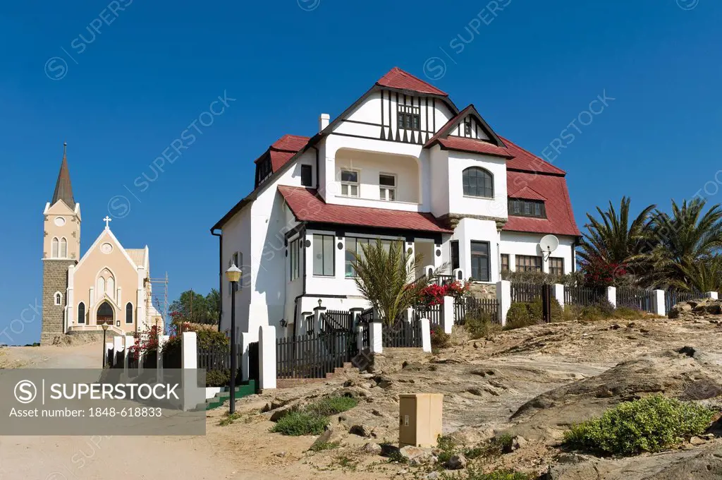House with half timbered elements and the rock church, Kirchstrasse street, Luederitz, Namibia, Africa