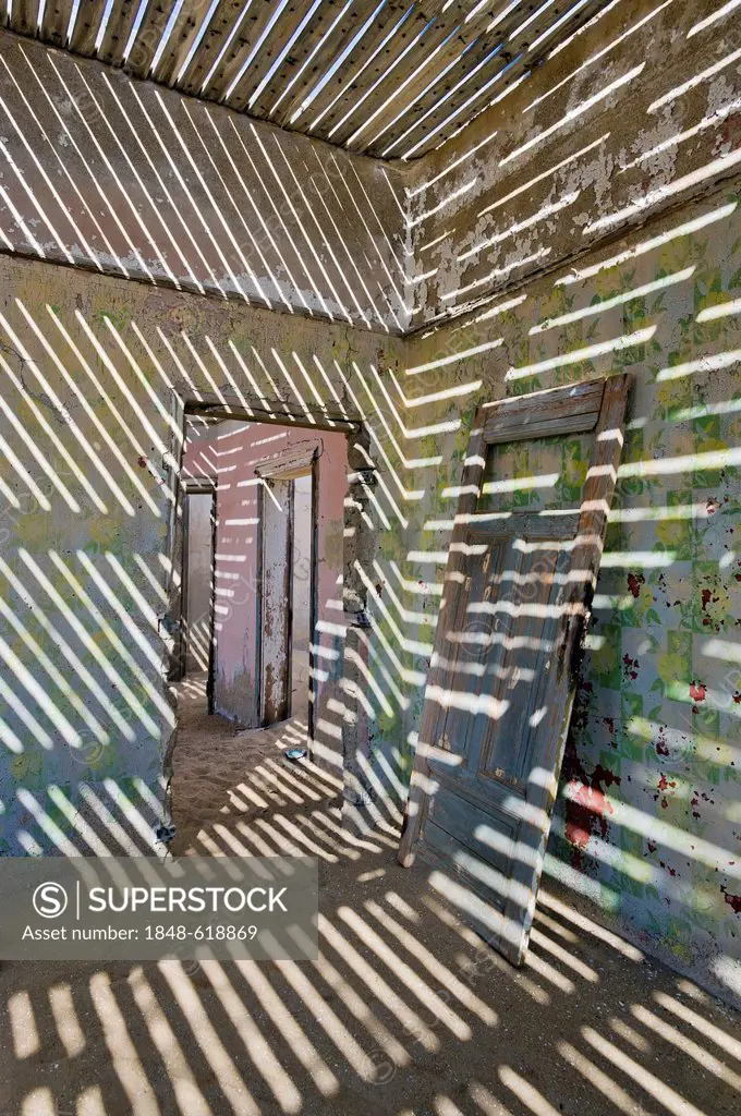 Shadows and a door in a ruined house, abandoned diamond mine, Kolmanskop, Namibia, Africa