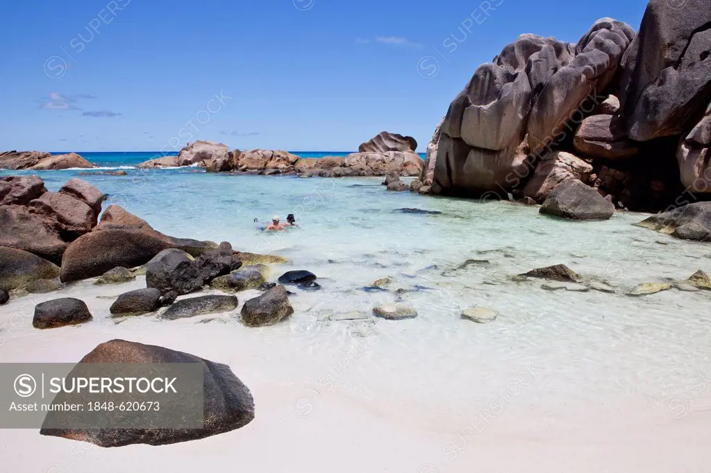 Rock pool, surrounded by giant granite blocks at Anse Cocos, La Digue, Seychelles, Africa, Indian Ocean