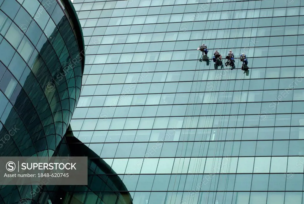 Window cleaners on a modern glass facade in Saigon, Ho Chi Minh City, Vietnam, Southeast Asia