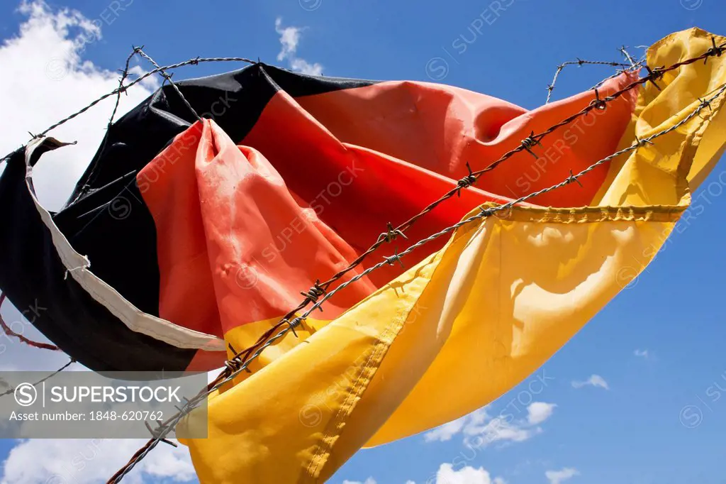 A German flag stuck in barbed wire