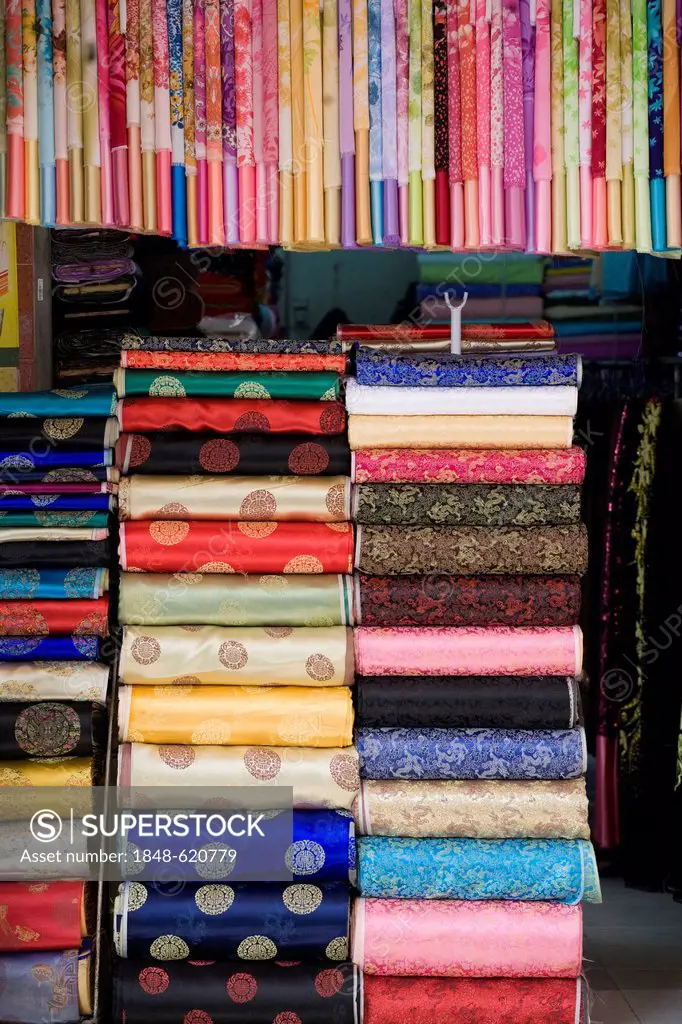 Window stacked with colourful silks, Hanoi, Vietnam, Southeast Asia, Asia