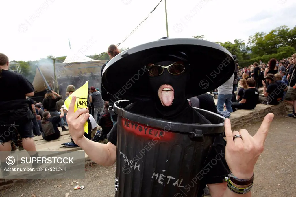 Metalfest 2012 at the Loreley open air stage, festival goer wearing a rubbish bin as a trash-metal outfit, St. Goarshausen, Rhineland-Palatinate, Germ...