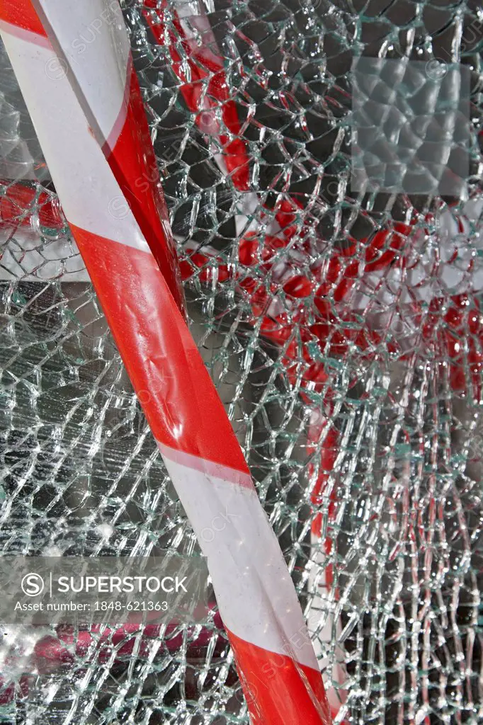 Barrier tape, broken store window, vandalism