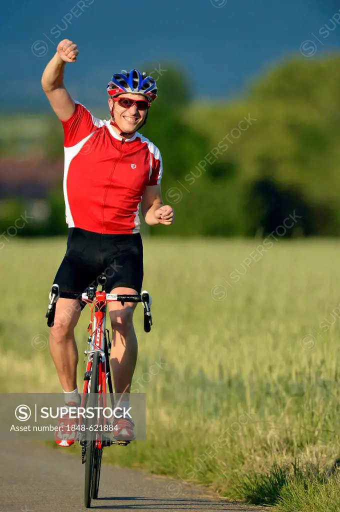Racing cyclist riding a bicycle, arms raised in a victory pose, jubilation, Waiblingen, Baden-Wuerttemberg, Germany, Europe, PublicGround
