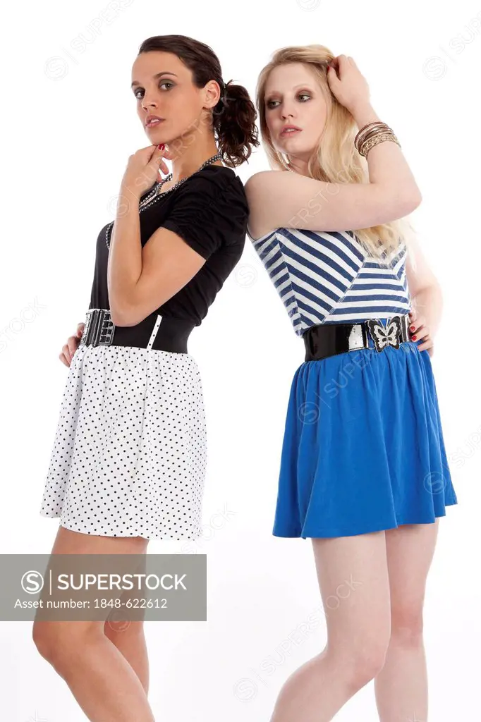 Two young women posing in short skirts