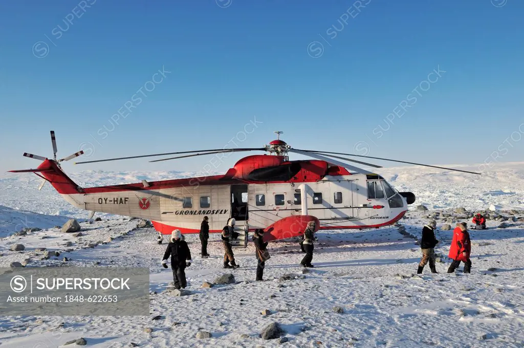 Sikorsky helicopter flying tourists to icebergs in the Ilulissat Fjord, Greenland, Arctic North America