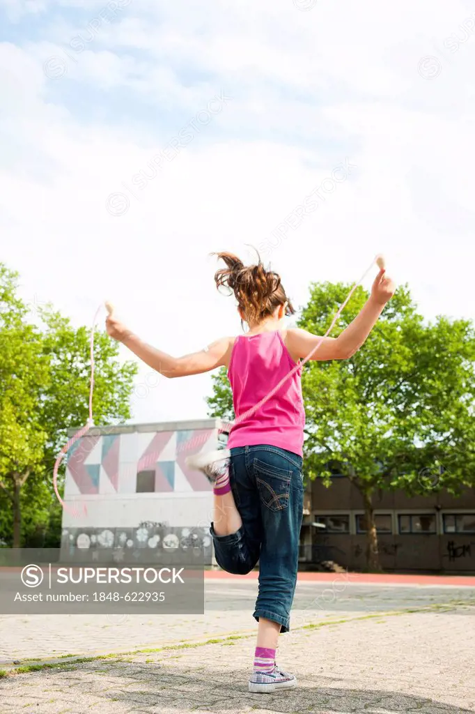 Girl skipping rope in the school playground