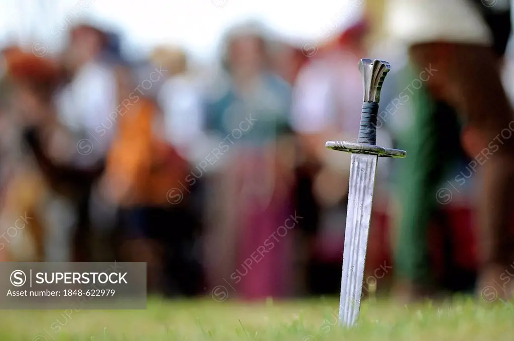 Sword with lansquenets or foot soldiers at back, historical re-enactment, Landsknecht Hurra 2012, Mittelberg, Upper Allgaeu, Swabia, Bavaria, Germany,...
