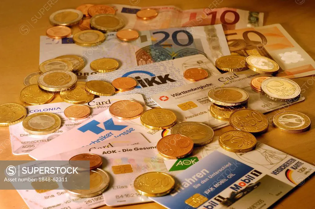 Different chip cards of German health insurance and Euro money