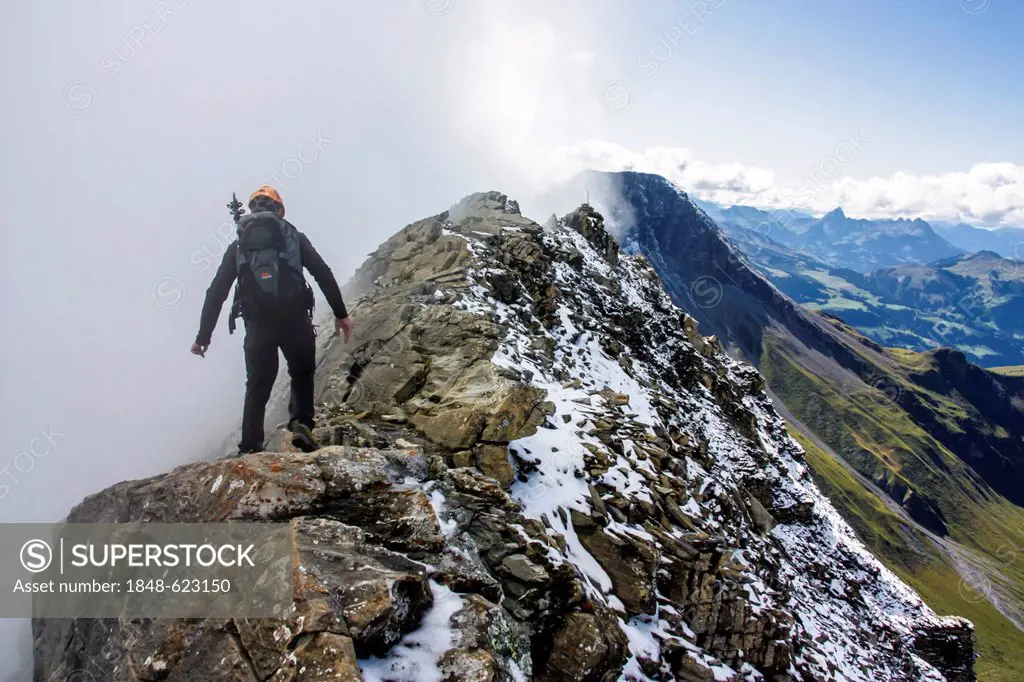 Mountain climber walking on the ridge leading to Gsuer, Adelboden, Bernese Oberland, Alps, Switzerland, Europe