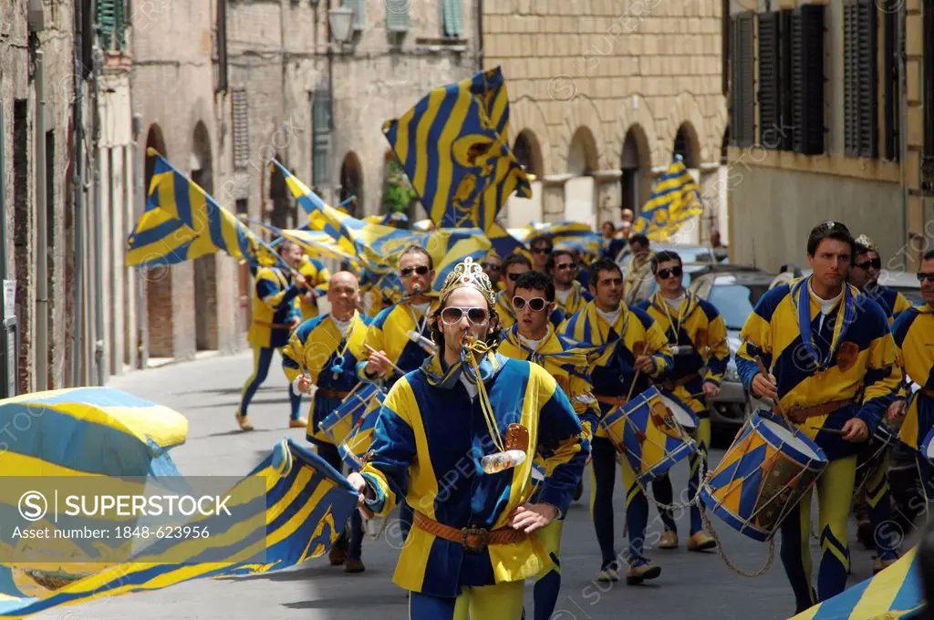 After the victory for their district, people in medieval costumes are moving through all districts, Palio, Siena, Tuscany, Europe