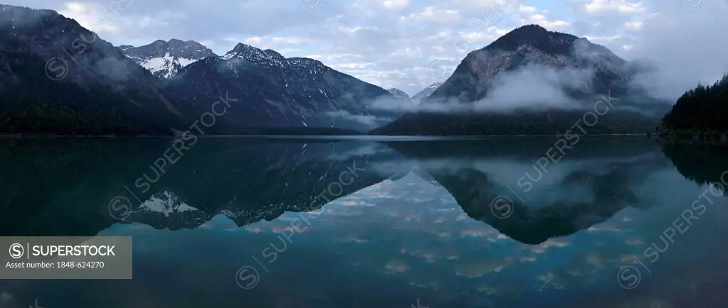 Mountains are reflected in Plansee lake, Tyrol, Austria, Europe