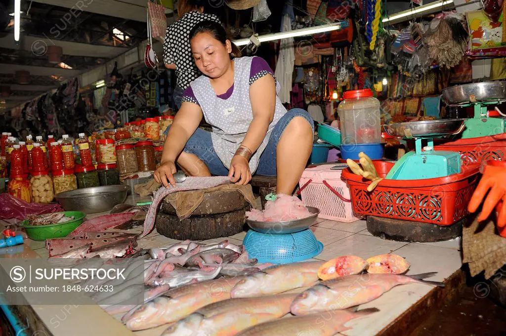 Fishmonger gutting a fish for a customer, Old Market in Siem Reap, Cambodia, Southeast Asia, Asia
