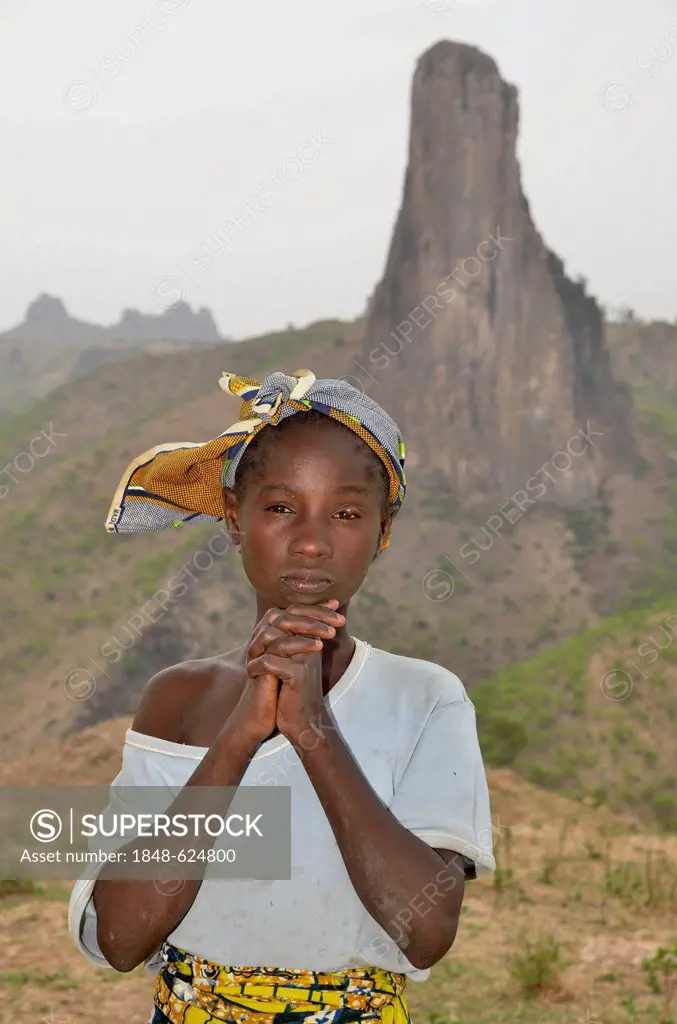 Young girl in front of the volcanic landscape at the village of Rhumsiki, Mandara Mountains, Cameroon, Central Africa, Africa
