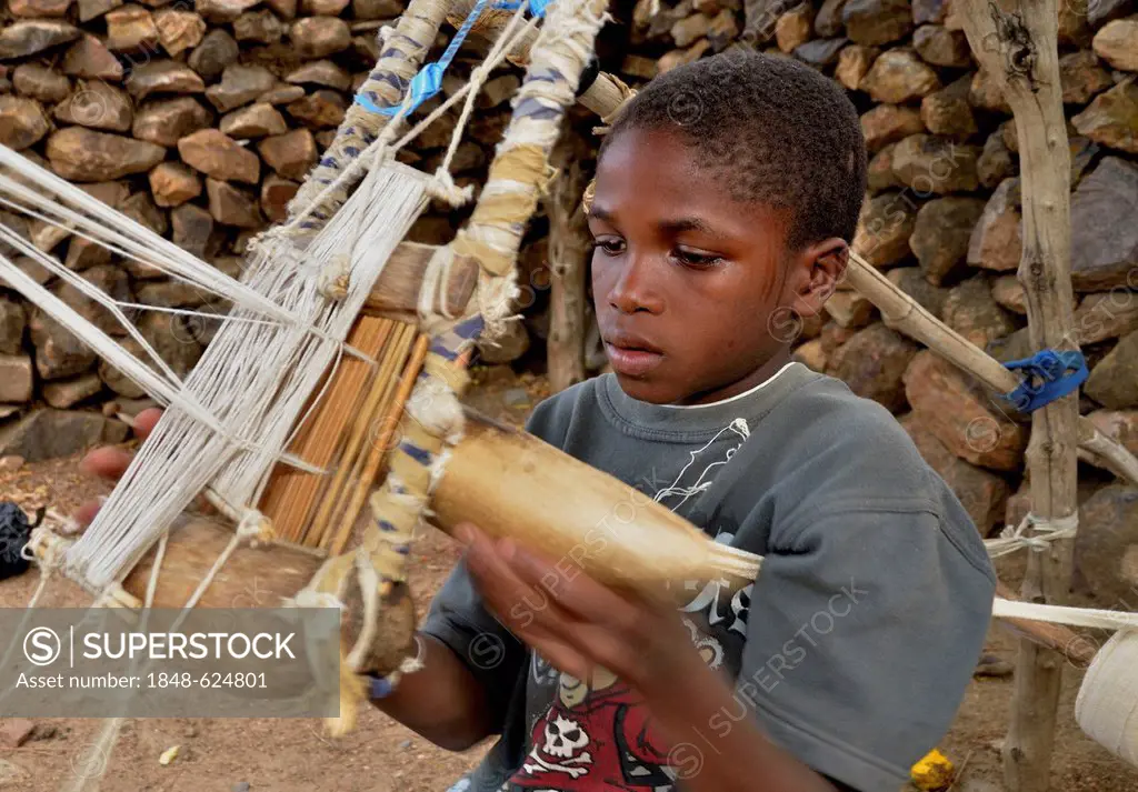 Boy working on a loom in the village of Rhumsiki, Cameroon, Central Africa, Africa
