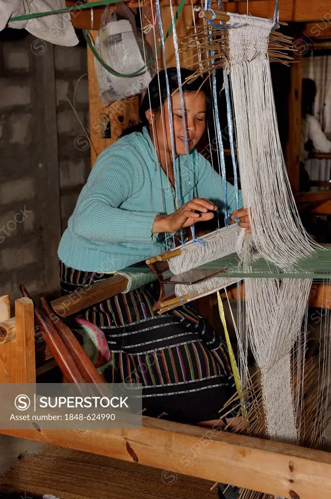 Weaver working on a hand loom in a silk factory near the town of Phansavan, Laos, Southeast Asia, Asia