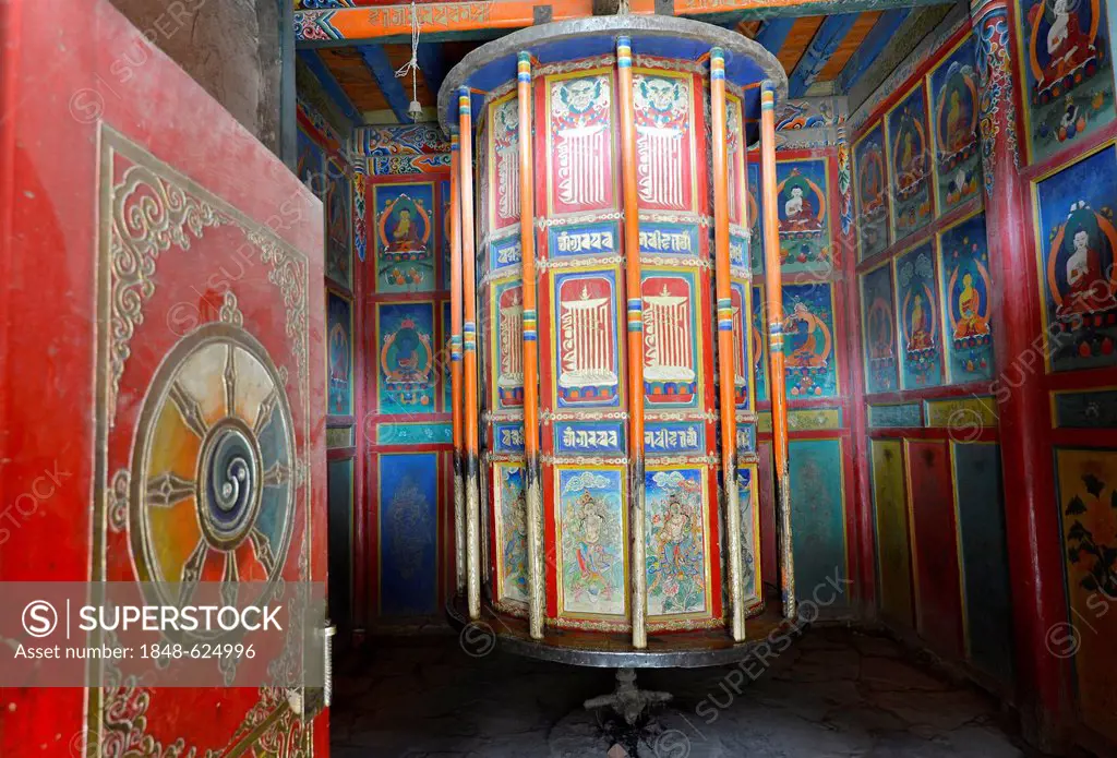 Tibetan Buddhism, wooden painted prayer wheels covered in Buddhist symbols, cylinder, at the cloister, kora at Labrang Monastery, Xiahe, Gansu, former...