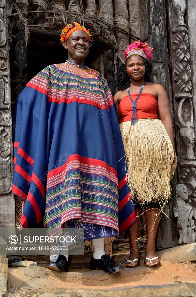 King Fon Abumbi II, head of one of the traditional kingdoms in north west Cameroon, in front of the Achum sanctuary at his seat of power with one of h...