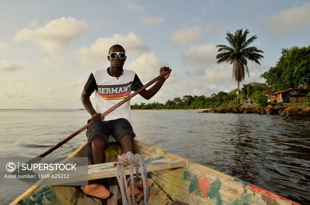Local man wearing a Germany t-shirt on a boat trip to Lobé Waterfall, near Kribi, Cameroon, Central Africa, Africa
