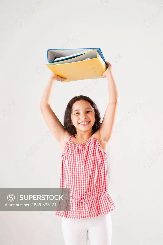 A girl holding folders above her head