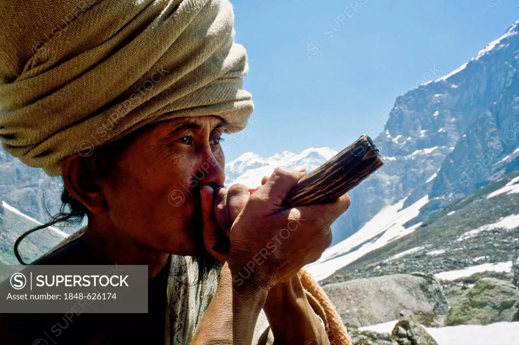 Shiva Sadhu smoking marihuana high up in the the mountains above Badrinath, Uttaranchal, India, Asia